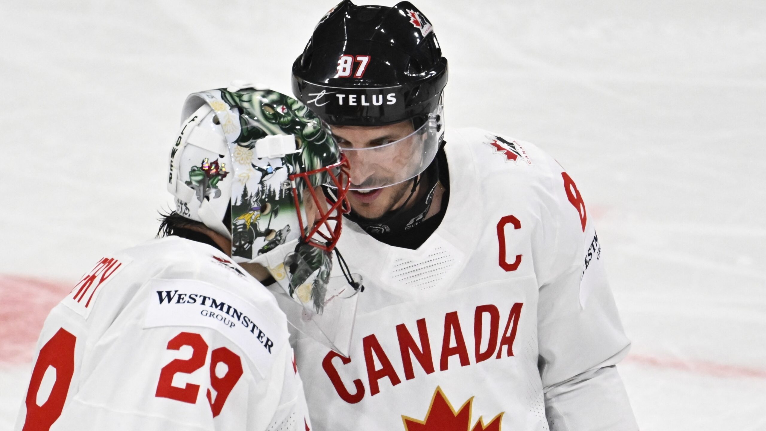 Canada's forward Sidney Crosby and Canada's goalkeeper Marc-Andre Fleury consult after winning the IIHF Ice Hockey World Championship group A match against Latvia ahead of the Canada vs France match on May 13, 2025.