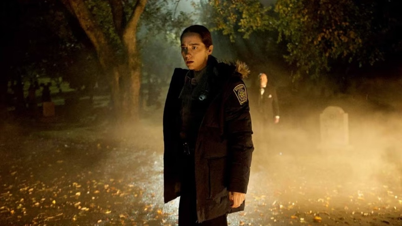 A nervous looking Detective Dana Cypress (Melanie Scrofano) in a fog-shrouded graveyard late at night, in a still from supernatural mystery "Revival"