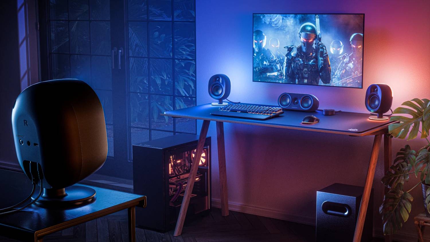 הגדרת מחשב בחדר עם SteelSeries Arena 9 רמקולים סביב שולחנות עם תאורת RGB