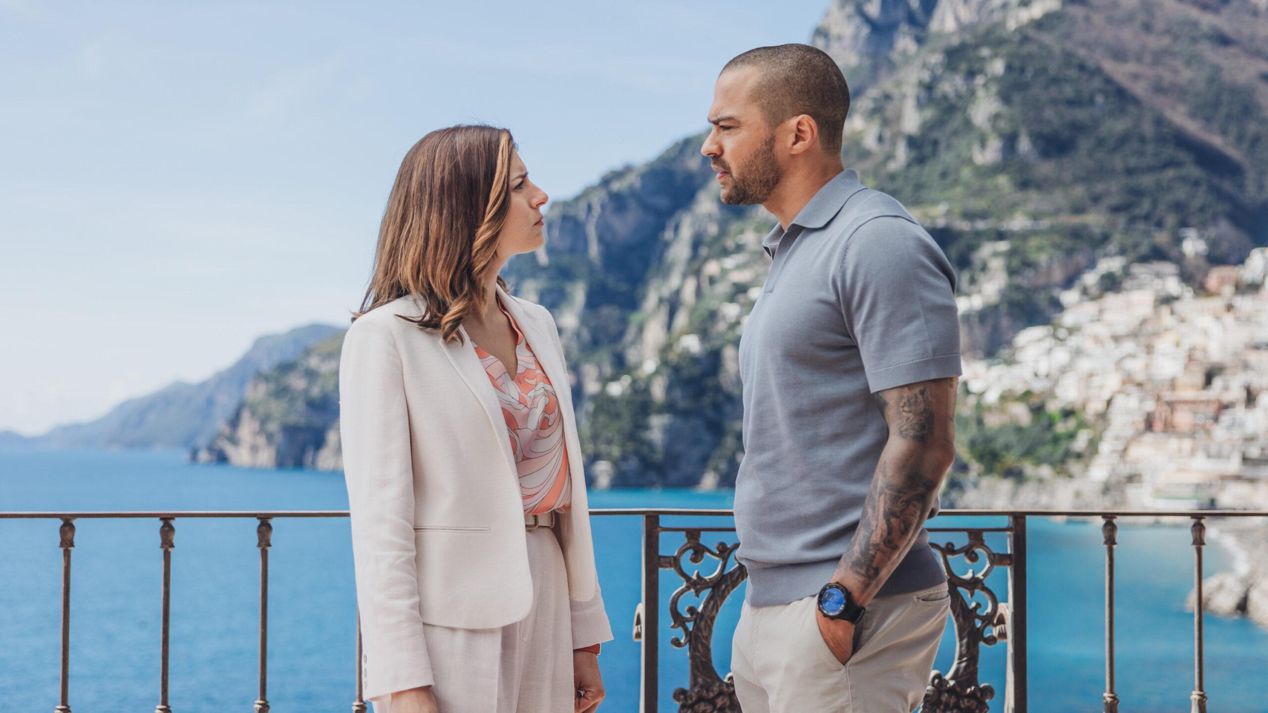 Daniel De Luca (Jesse Williams, right) chats with a hotel staff member in a scene from Prime Video's "Hotel Costiera"
