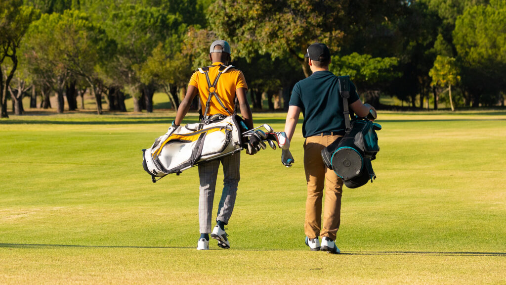 Golfers carrying their bags
