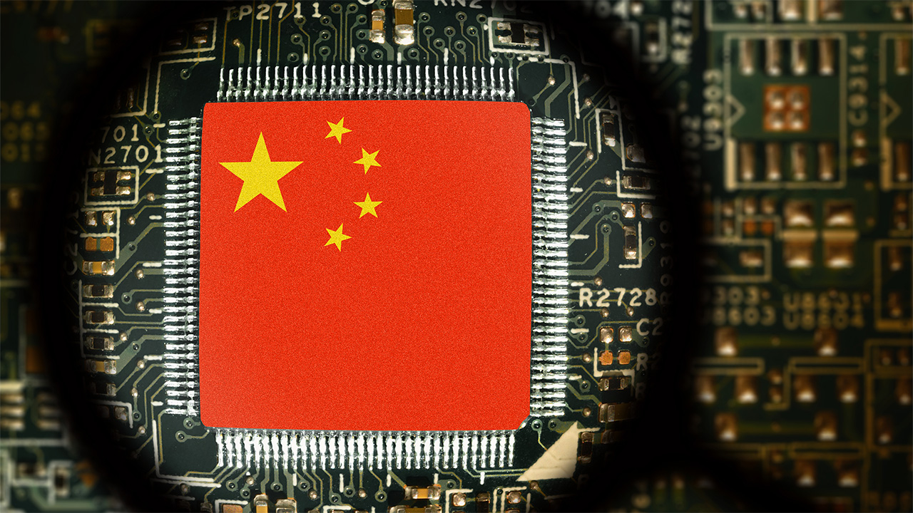 Chinese flag on a computer board, viewed through a magnifying glass
