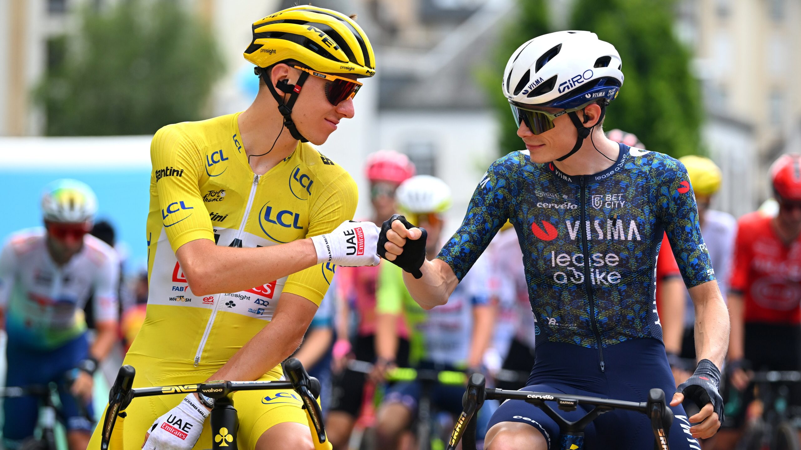 Tadej Pogacar and Jonas Vingegaard exchange a gesture before a stage at the Tour de France.