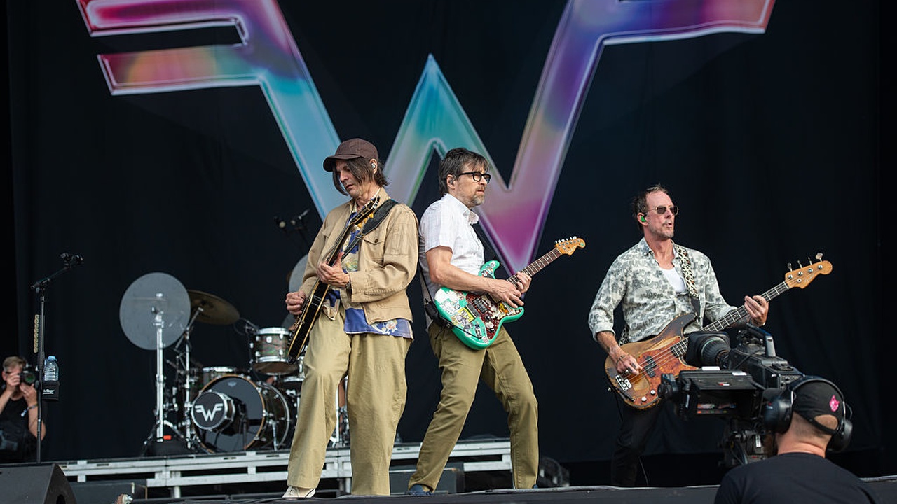 Brian Bell, Rivers Cuomo and Scott Shriner of Weezer perform during Download Festival ahead of the band's appearance at Glastonbury 2025