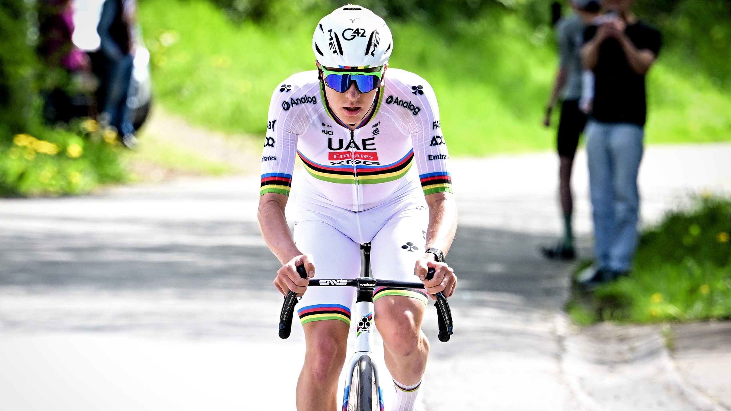 Tadej Pogacar of Slovenia and UAE Team Emirates, wearing all white, pedals his bike ahead of the Criterium du Dauphone 2025