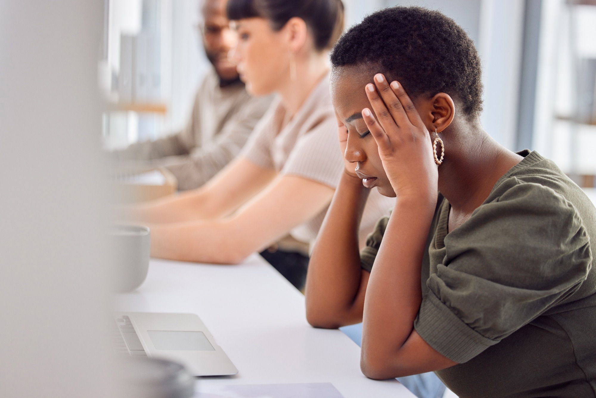 woman with headache in office with