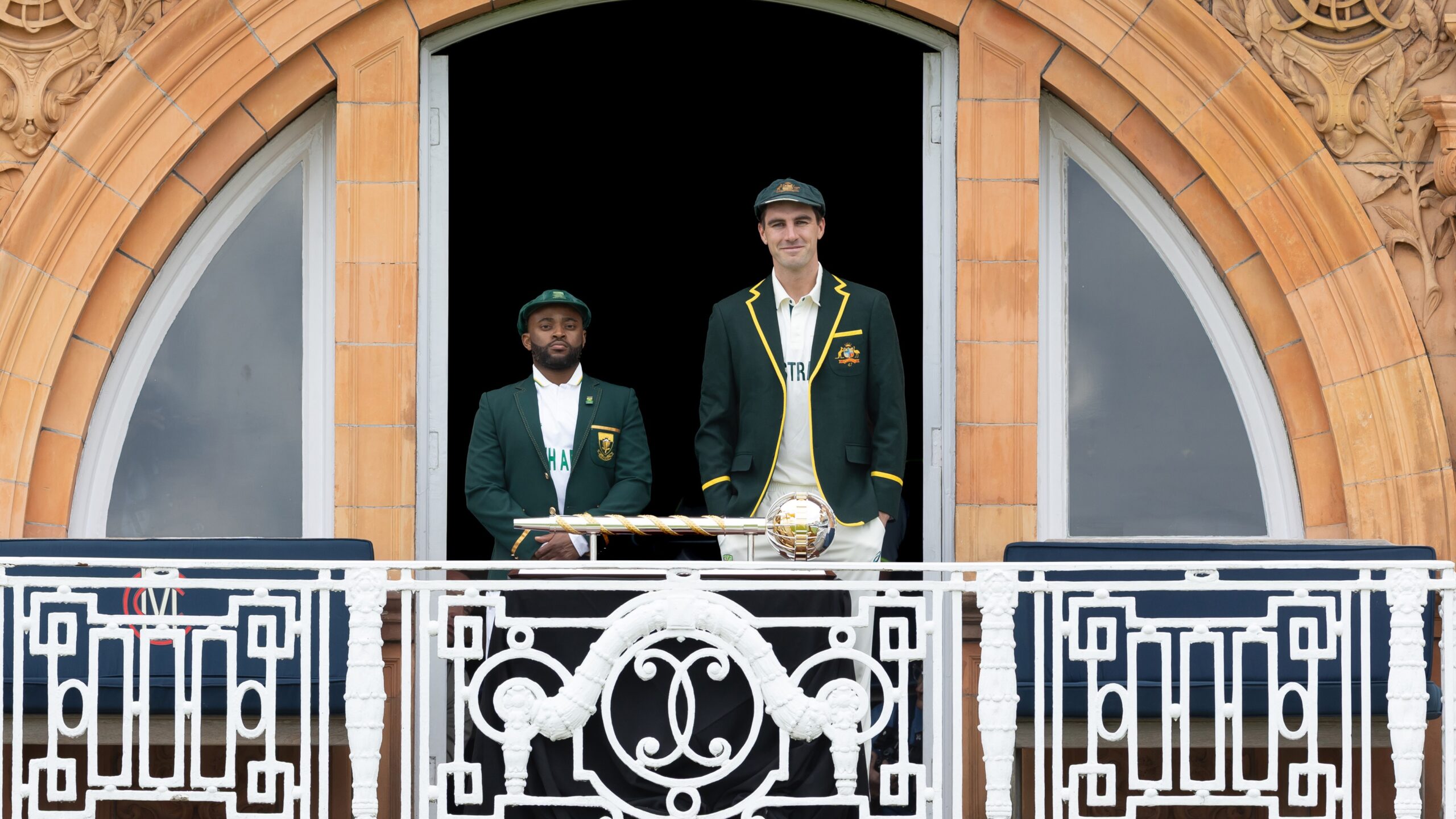 Temba Bavuma and Pat Cummins stand alongside the World Test Championship trophy 2025.