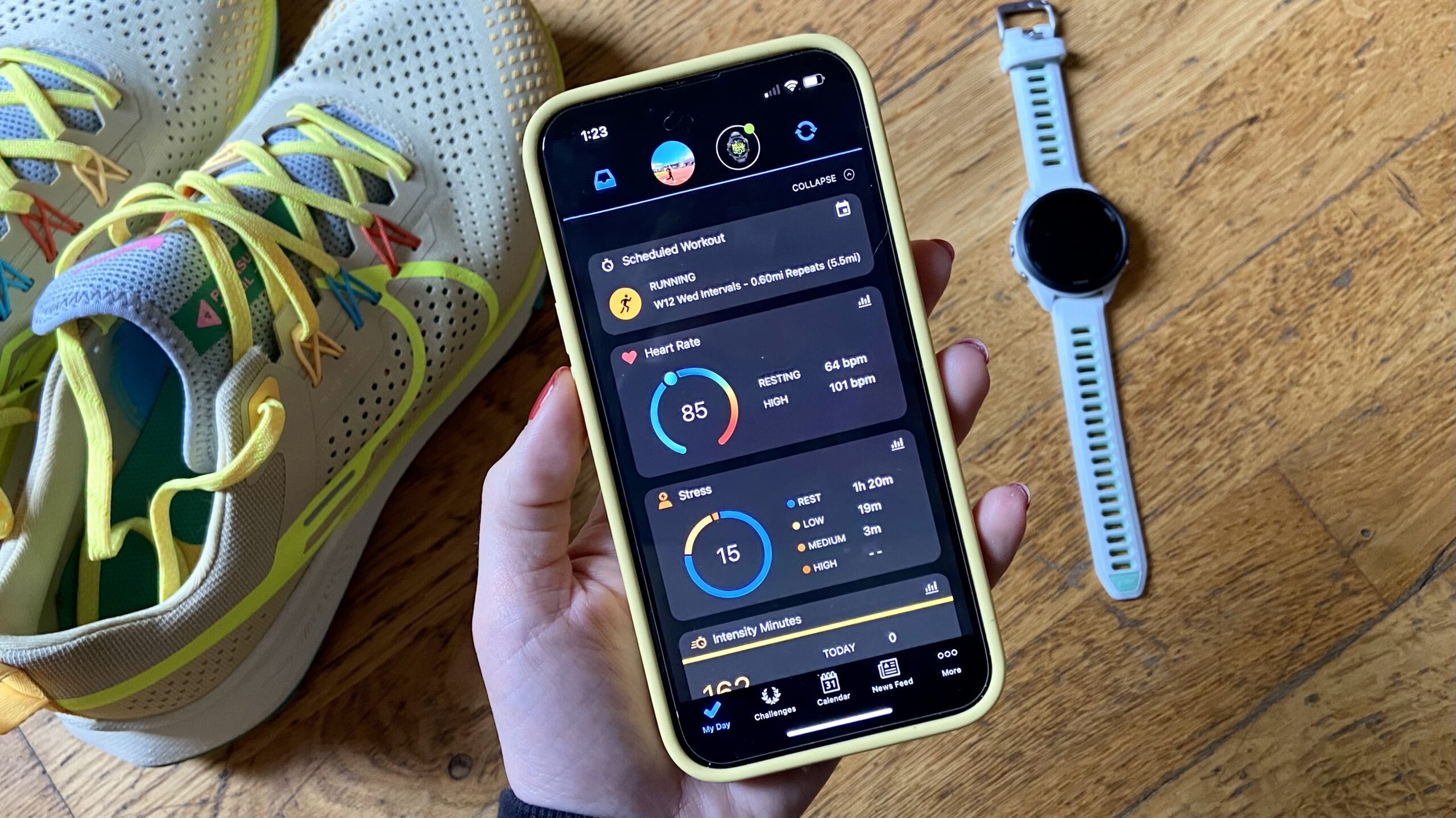 a photo of a hand holding a phone with Garmin Connect app