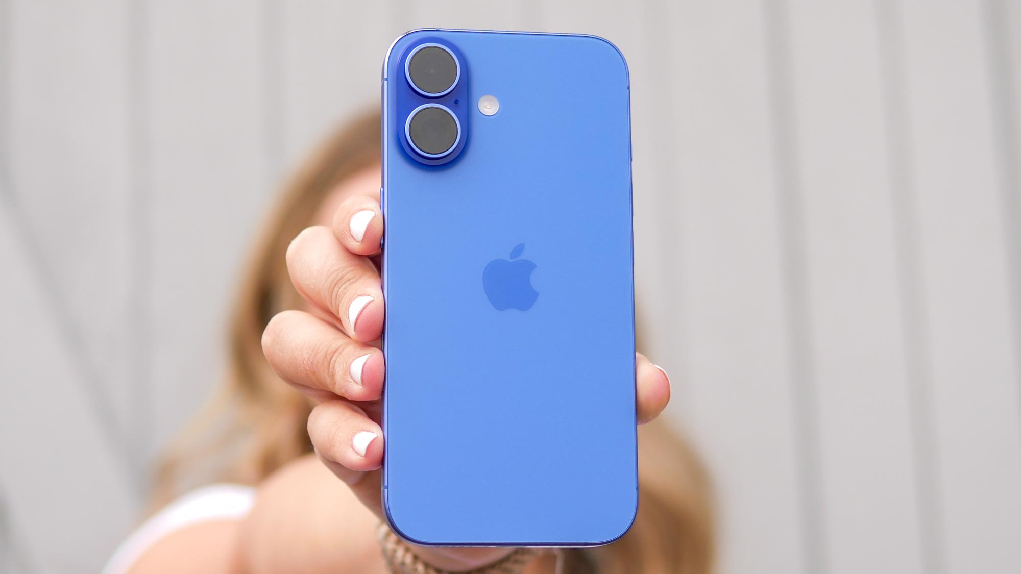 Apple iPhone 16 held in the hand.