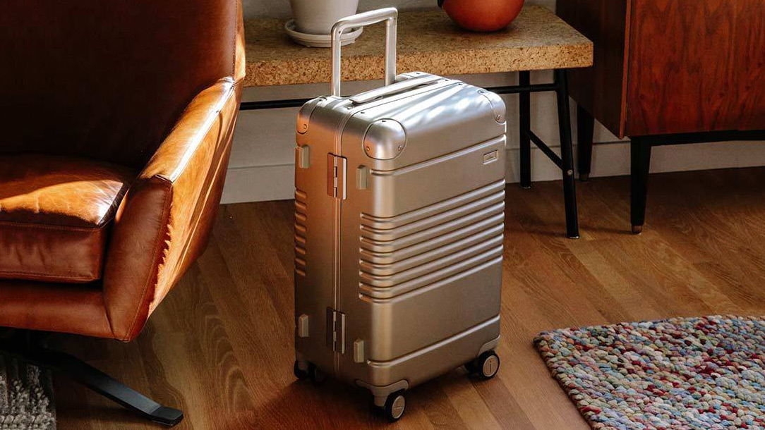 Arlo Skye The Frame Carry-On Luggage on a hardwood floor