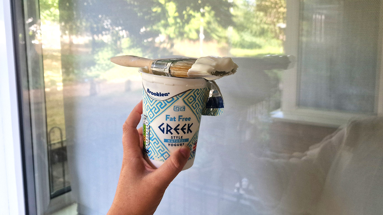 spreading yogurt on a window