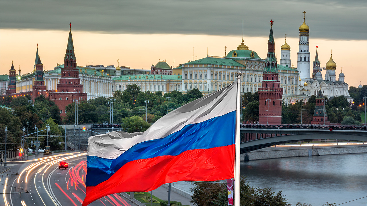 Russian flag flying, with Kremlin in the background