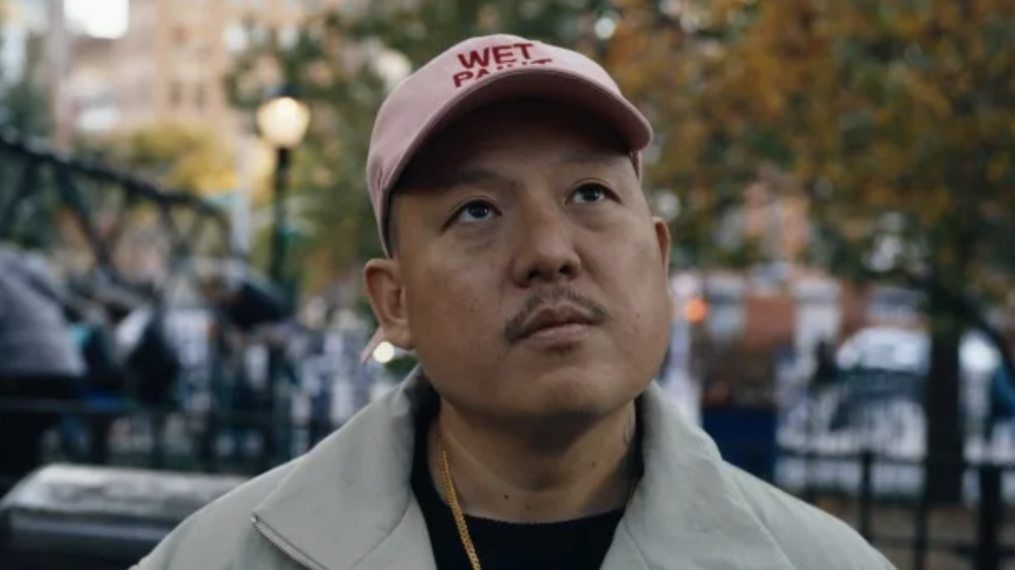 Eddie Huang director of Vice documentary 2025 wearing a pink 'Wet Paint' baseball cap