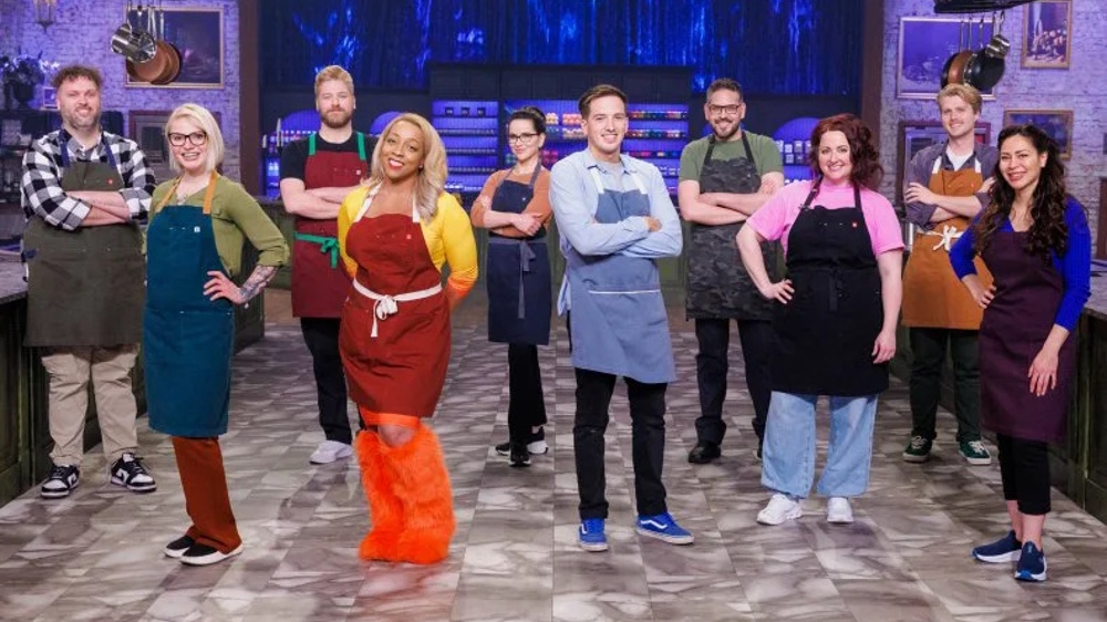 The 10 contestants of the 'Halloween Baking Championship' season 11 line up in the kitchen.