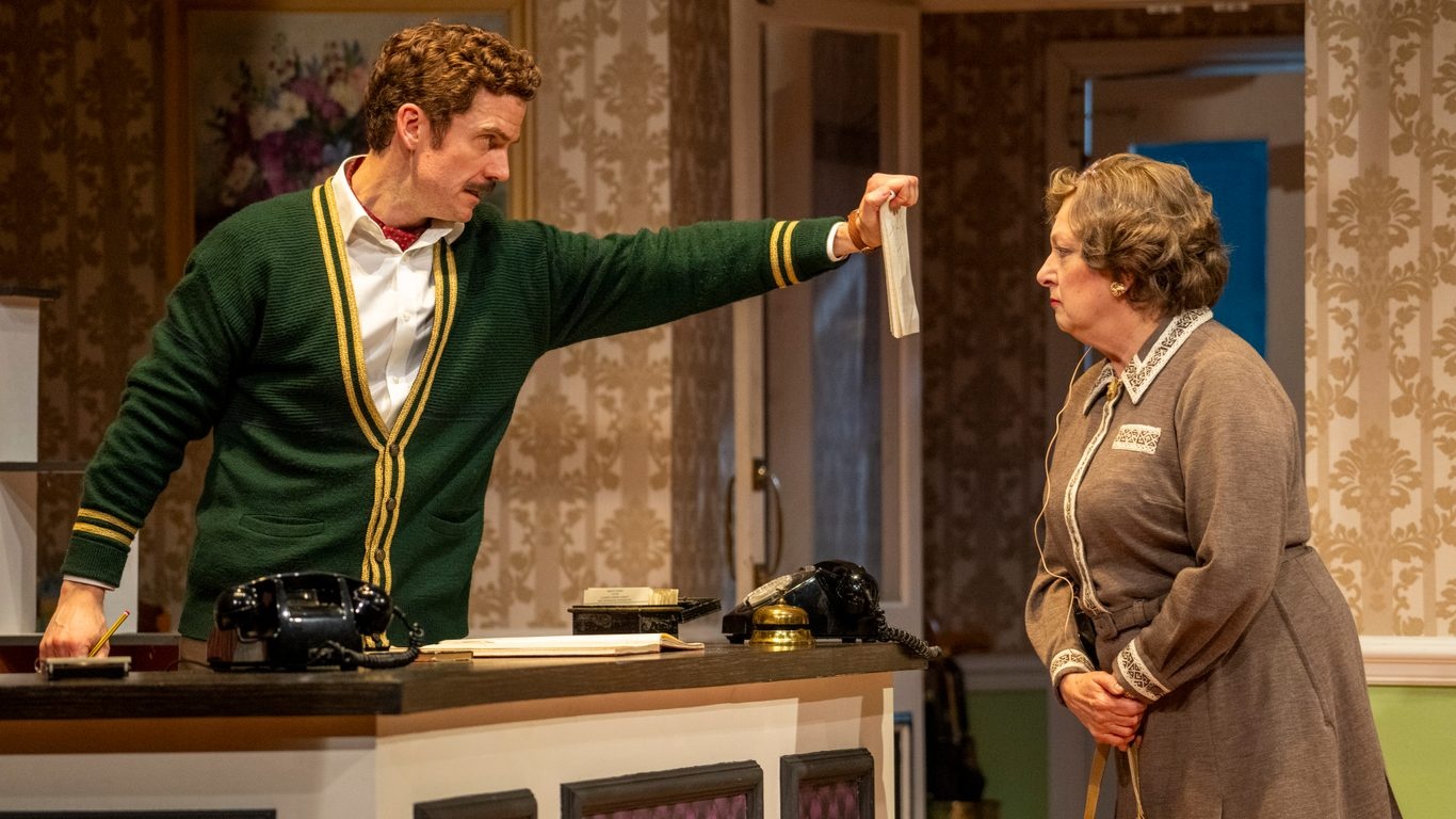 Basil Fawlty (played by Adam Jackson-Smith) has a one way conversation with Mrs Richards (Rachel Zen) in "Fawlty Towers: The Play" on U&amp;Gold TV