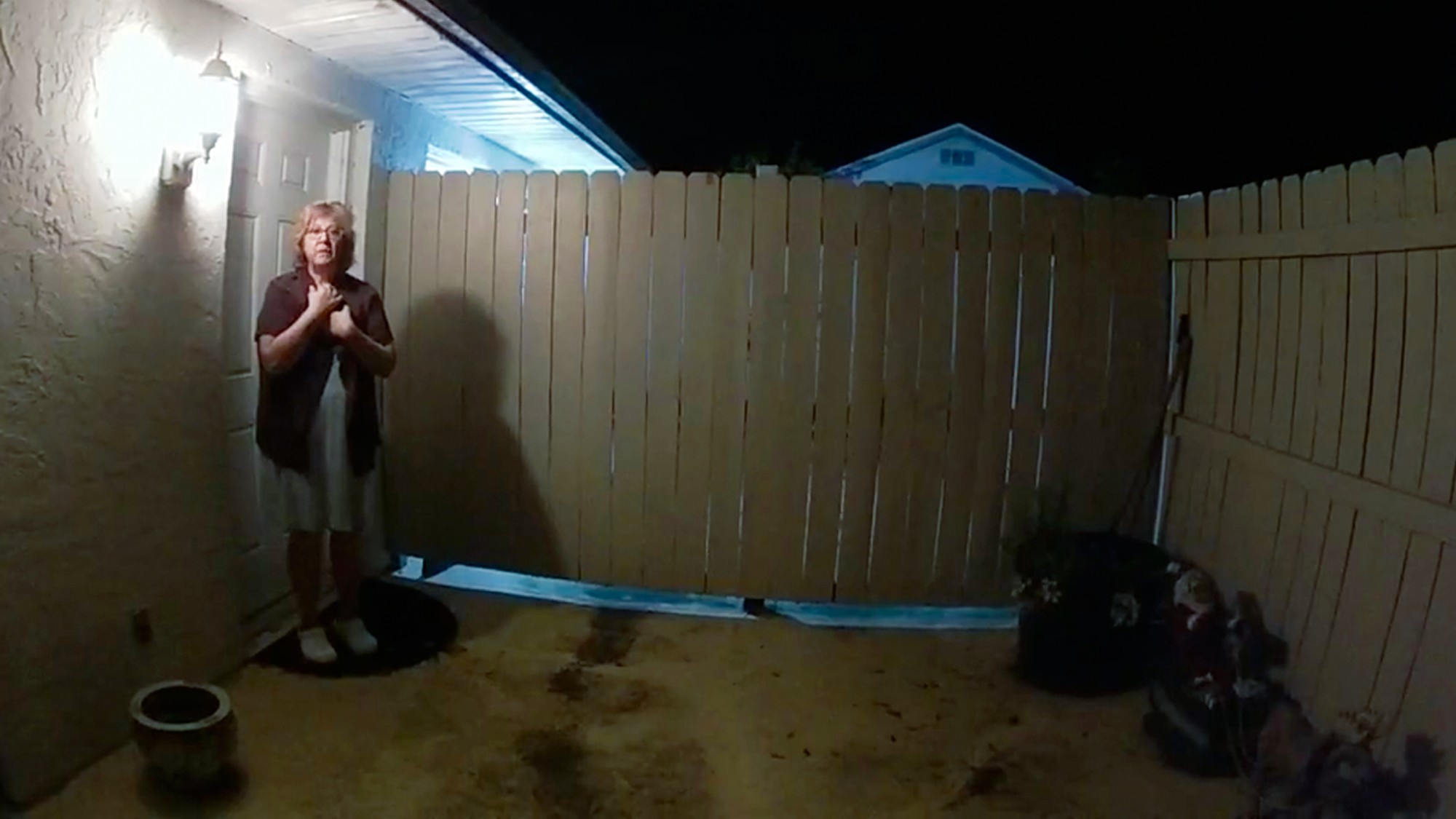 Susan Lorincz stands just outside the back door of her home, as seen on police body cam footage in the documentary "The Perfect Neighbor" on Netflix.