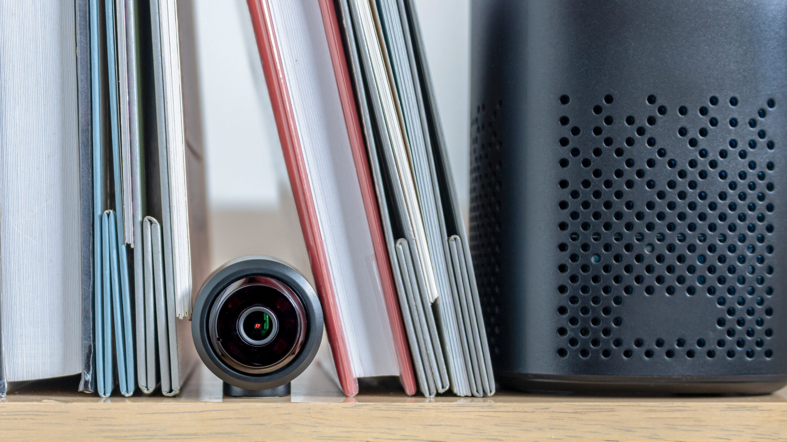 A small security camera hidden in a bookshelf