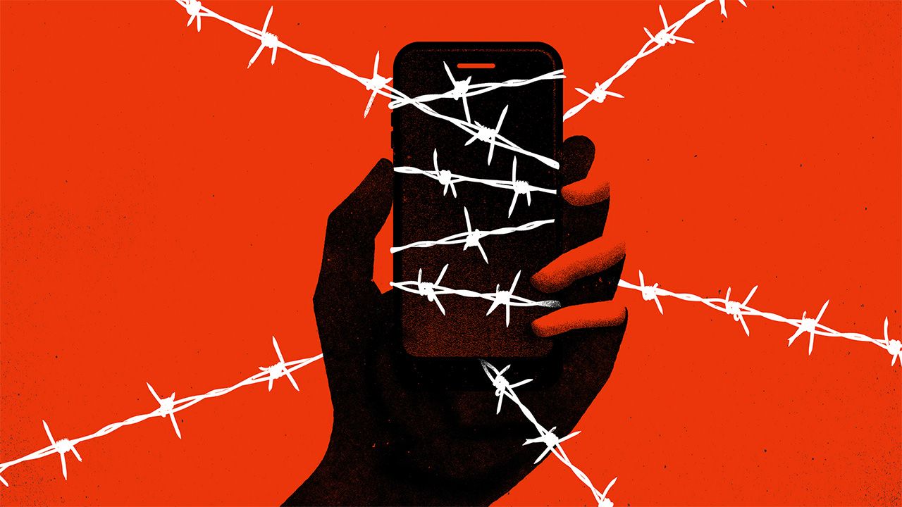 Striking black and red image of a hand holding phone, covered in barbed wire
