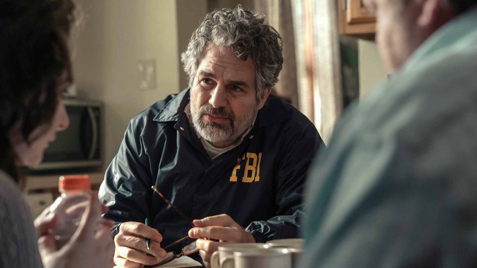 Mark Ruffalo sits across a table from some civilians in a scene from HBO Max's "Task"