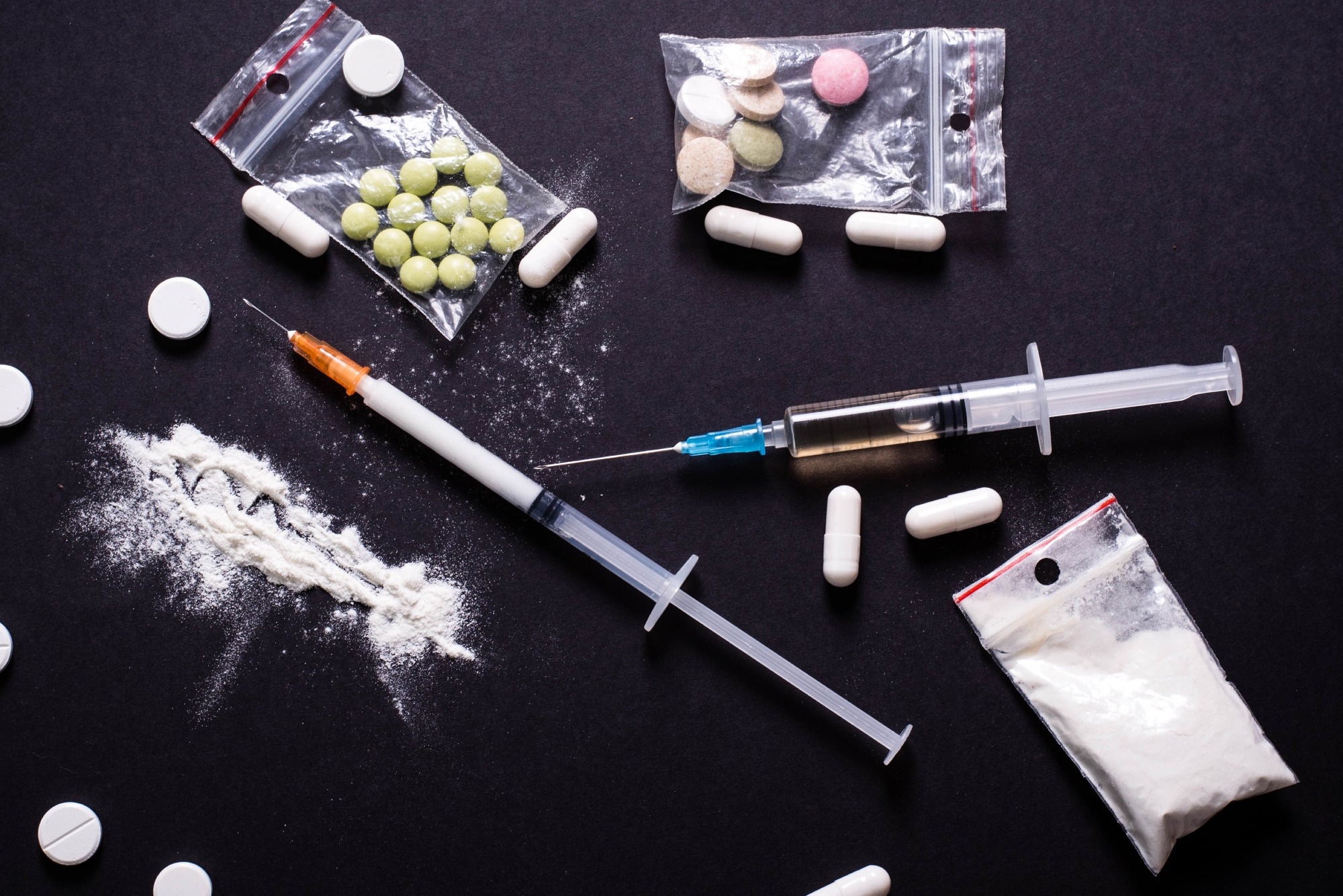Hard drugs on dark table
