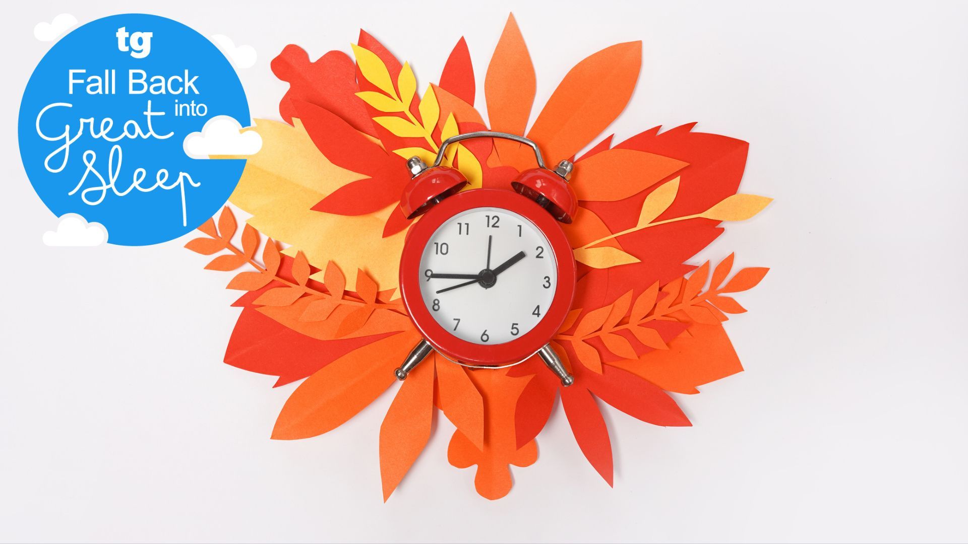 A red alarm clock with a background of illustrated autumn leaves