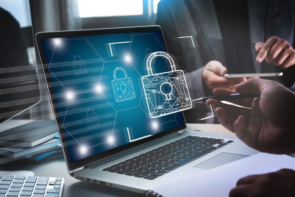 A person securing their laptop with antivirus software
