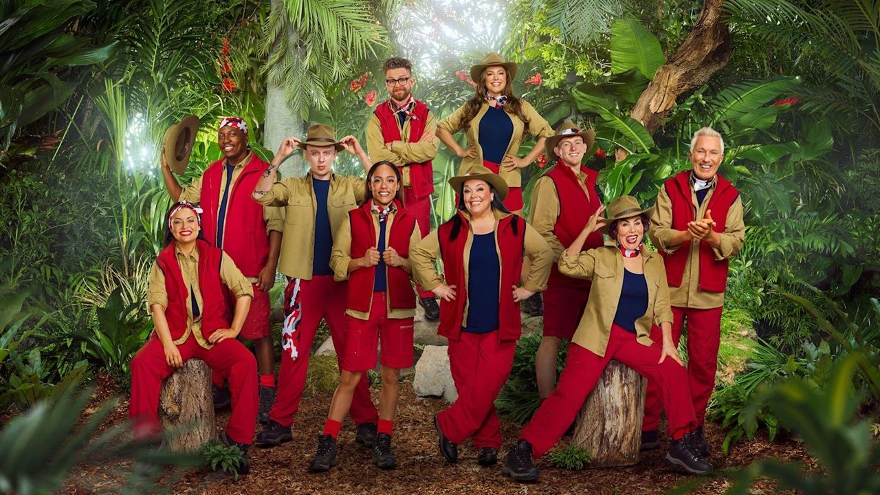 This year's celebrity campmates pose for a group photo against a lush green backdrop ahead of entering the Aussie jungle in "I'm a Celebrity" 2025.