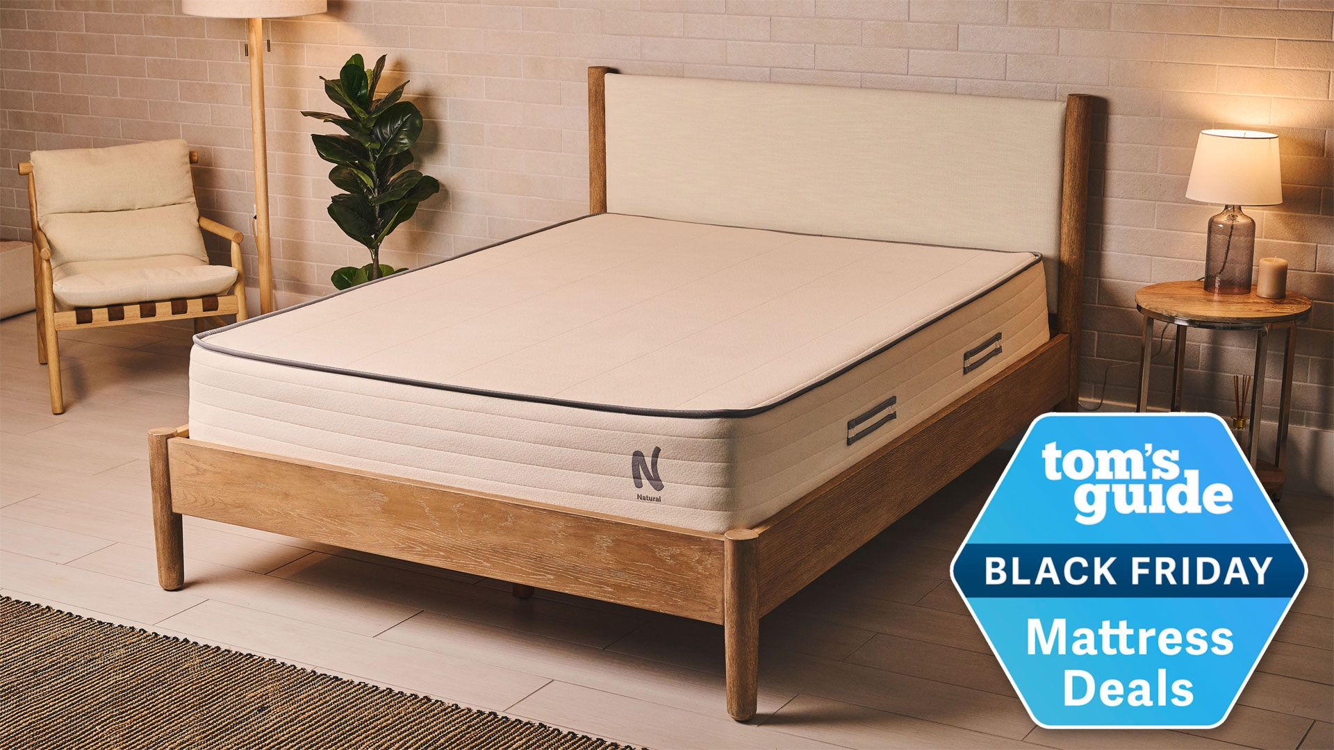 The Nolah Natural 11 Mattress in a well-lit bedroom with a Tom's Guide Black Friday Mattress Deals badge overlaid