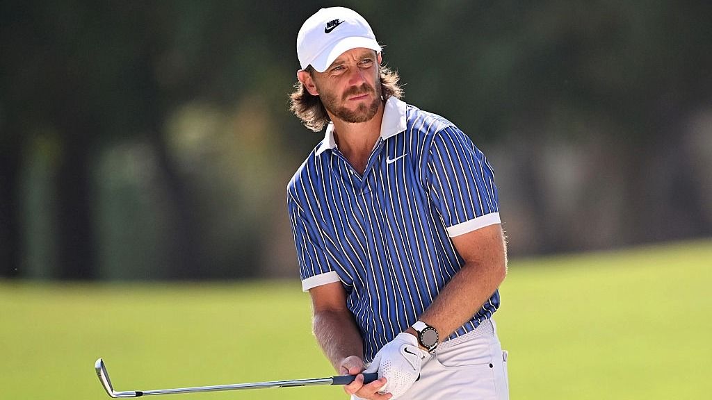 Tommy Fleetwood prepares for a golf shot at the DP World Tour Finals.