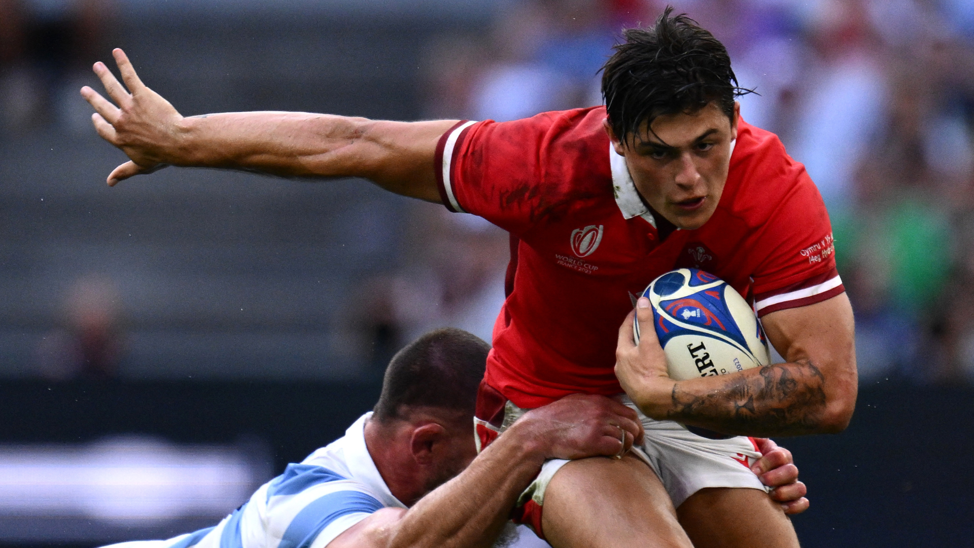 Wales' wing Louis Rees-Zammit (R) is tackled by Argentina's flanker Marcos Kremer during the France 2023 Rugby World Cup quarter-final match between Wales and Argentina at the Stade Velodrome in Marseille, south-eastern France, on October 14, 2023.