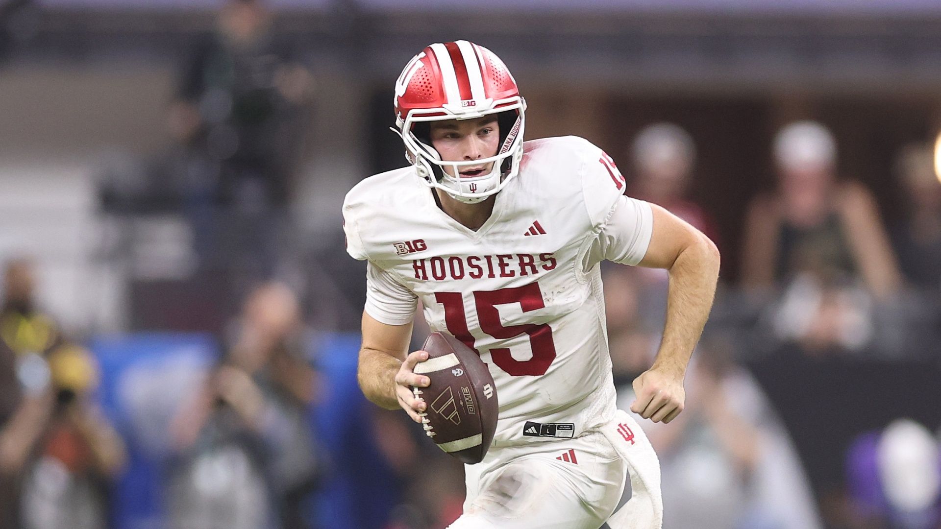 Indiana Hoosiers quarterback and Heisman Trophy winner Fernando Mendoza running with the ball