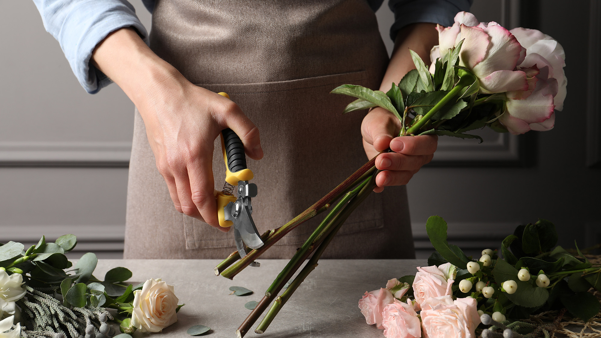 חנות פרחים גוזרת גבעולים של פרחים