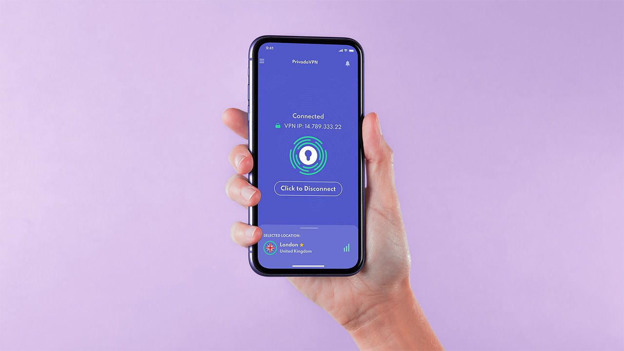 Hand holding iPhone with PrivadoVPN open on a lilac background
