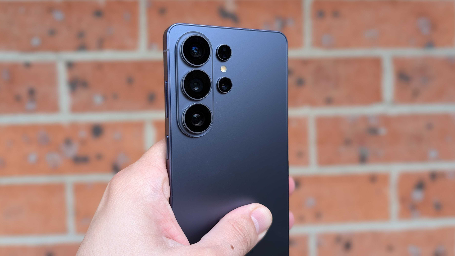 מבט מאחור של ה-Samsung Galaxy S26 Ultra מוצמד לקיר לבנים