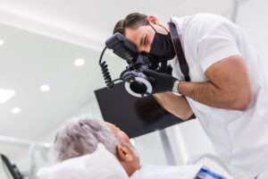 healthcare worker taking photographs of mature patient