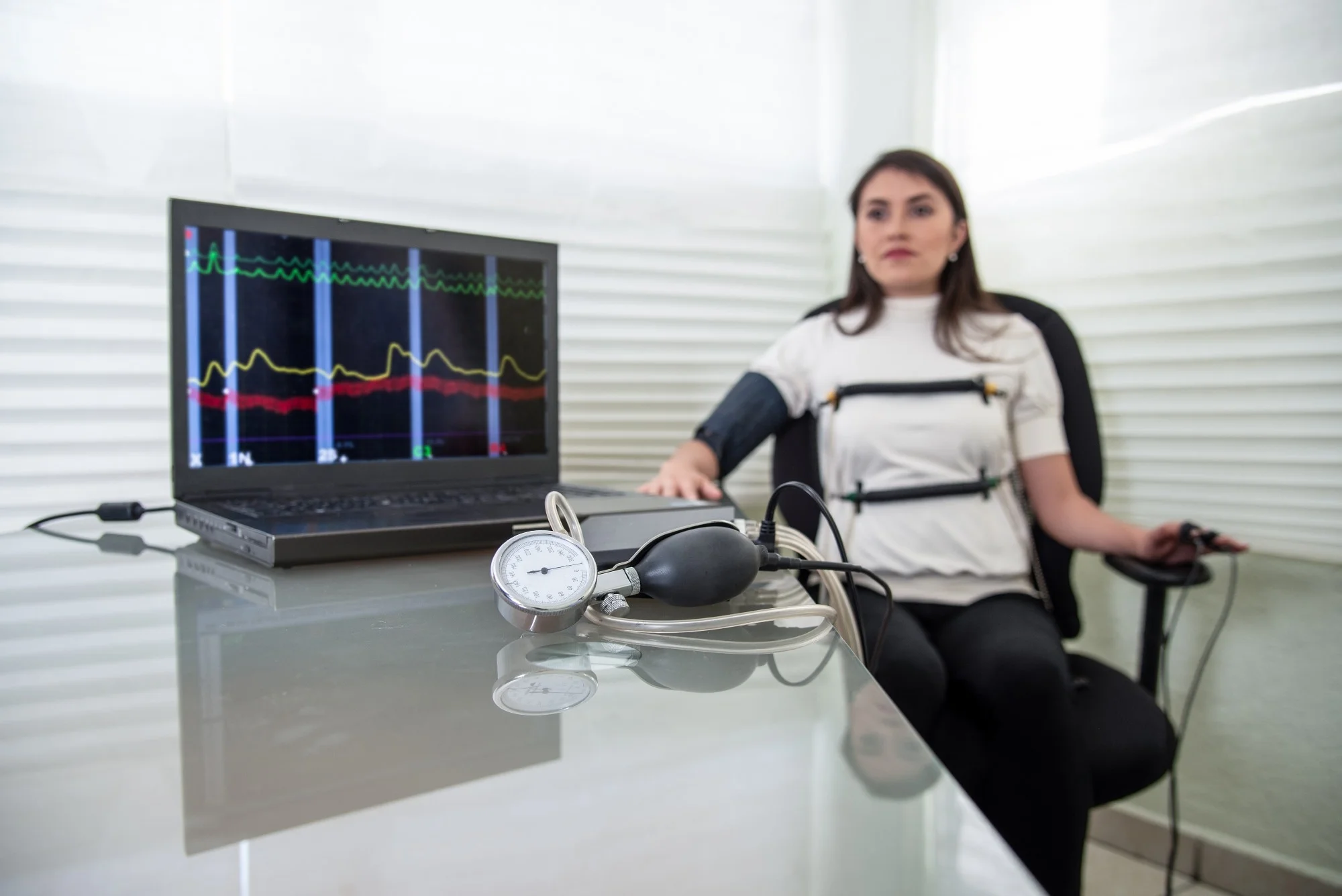 woman in polygraph test with measuring devices to know the truth, scales, hoses and measuring tubes on her body