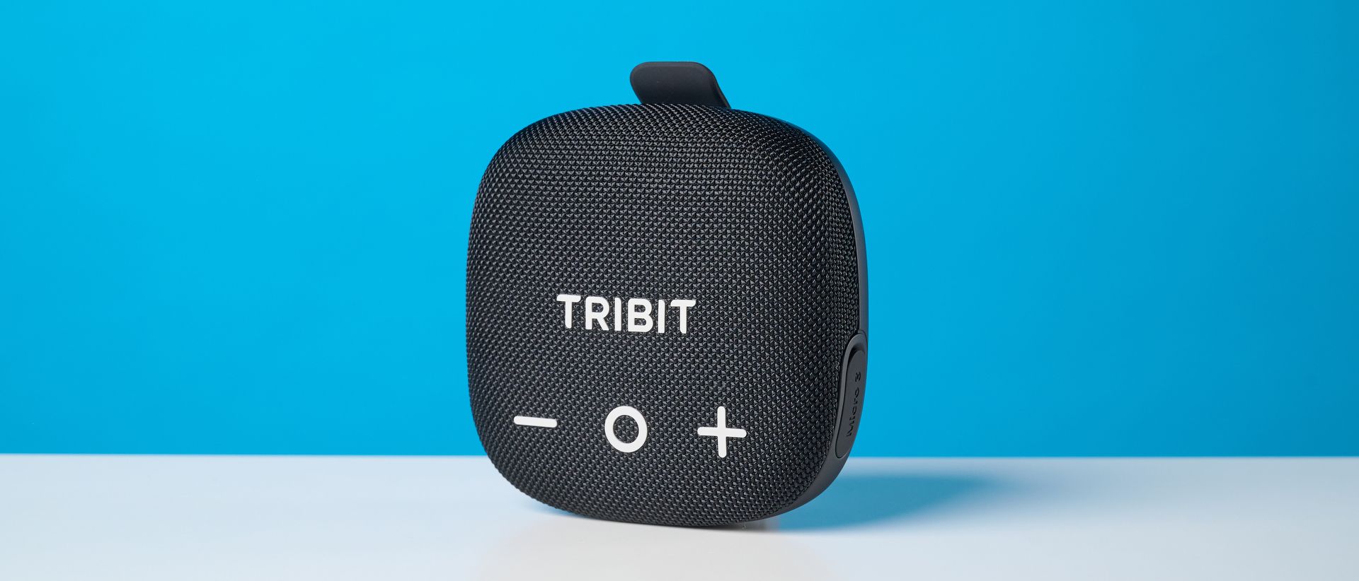 Tribit StormBox Micro 3 in black photographed in front of a blue background