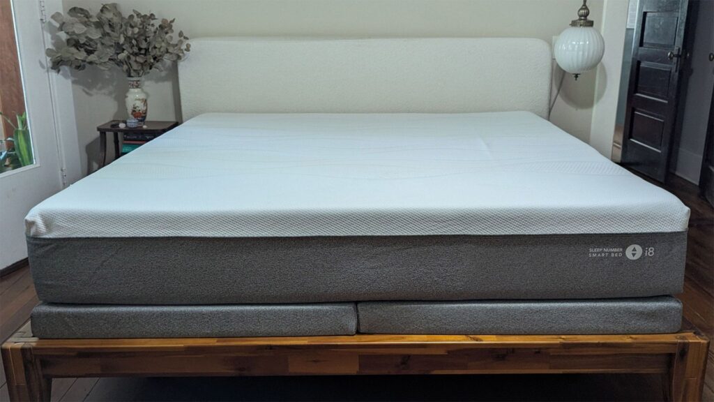 Grey and white Sleep Number i8 smart mattress on wooden bedframe