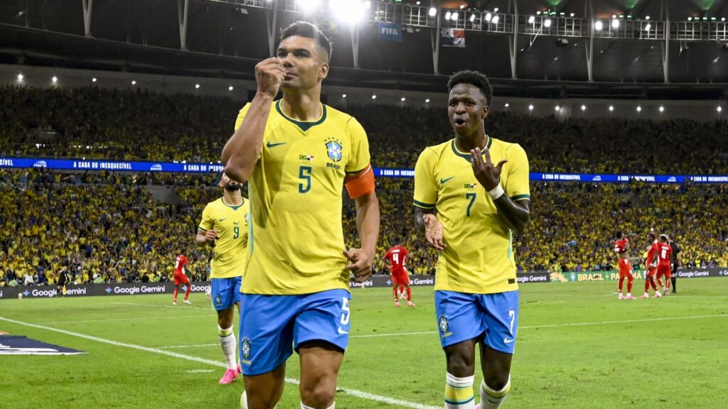 Brazil's Casemiro celebrating with Vinicius Junior