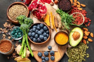 high flavanol food selection including blueberries, and brocolli on dark background. Superfood assortment. Top view,.
