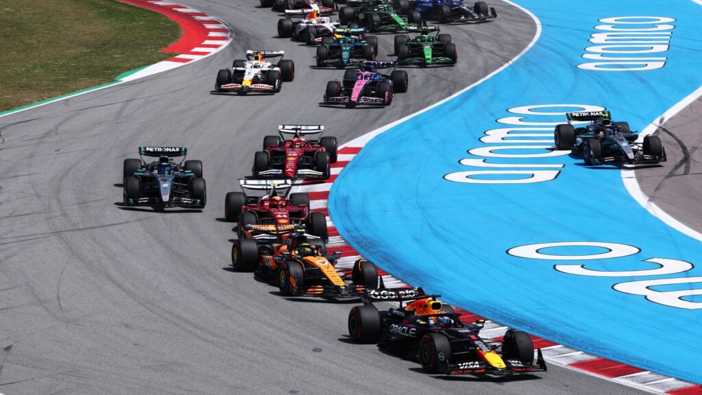 Max Verstappen of Red Bull Racing leads a tightly packed field of drivers during the F1 Grand Prix of Spain at Circuit de Barcelona-Catalunya.