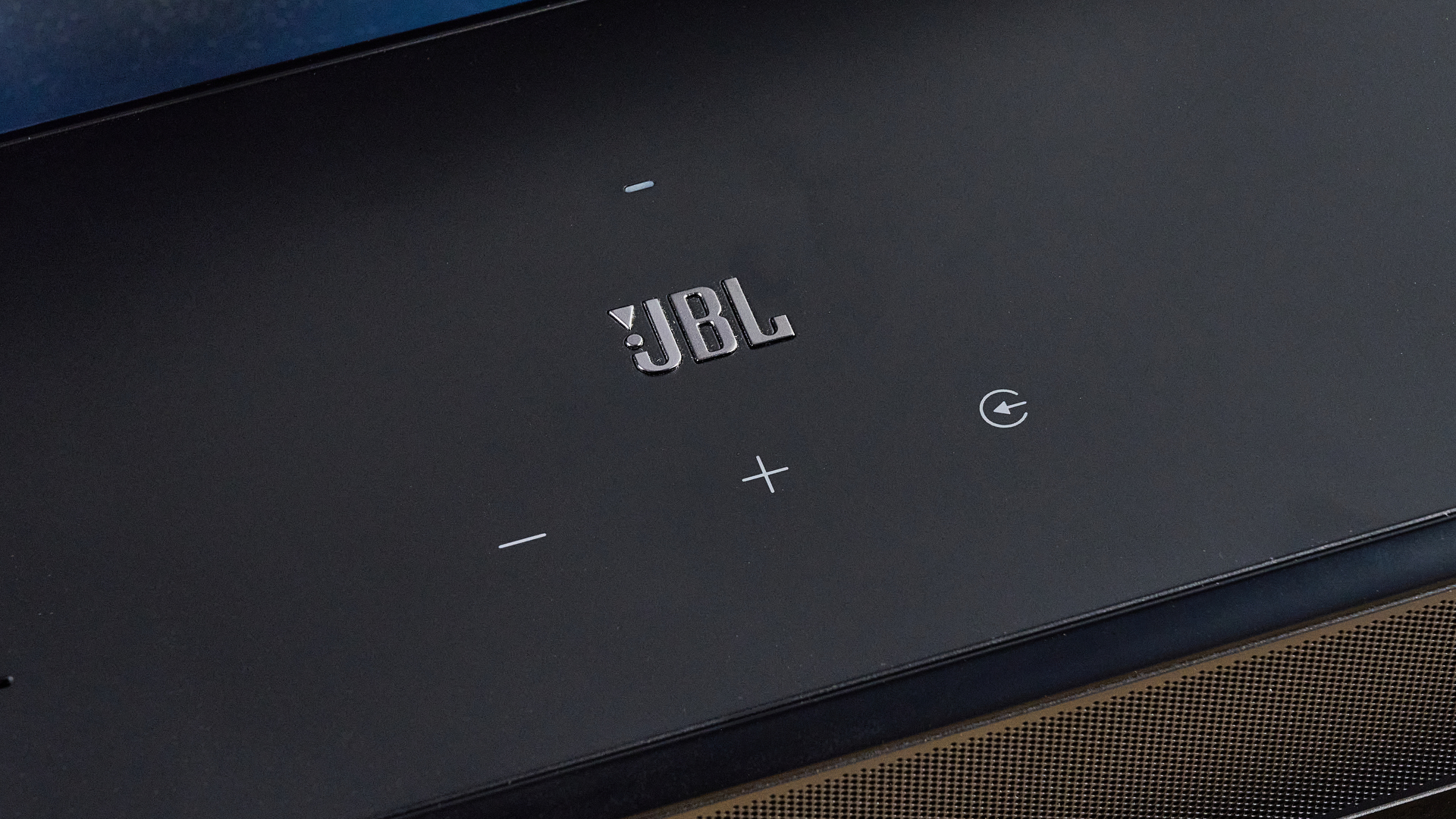 ה-jbl bar 1300xmk2 בשחור שצולם על רקע המדריך הכחול של טום
