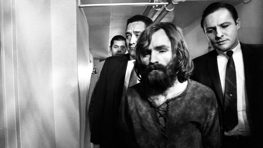 Charles Manson leaving court after deferring a plea on the Tate-LaBianca murder charges