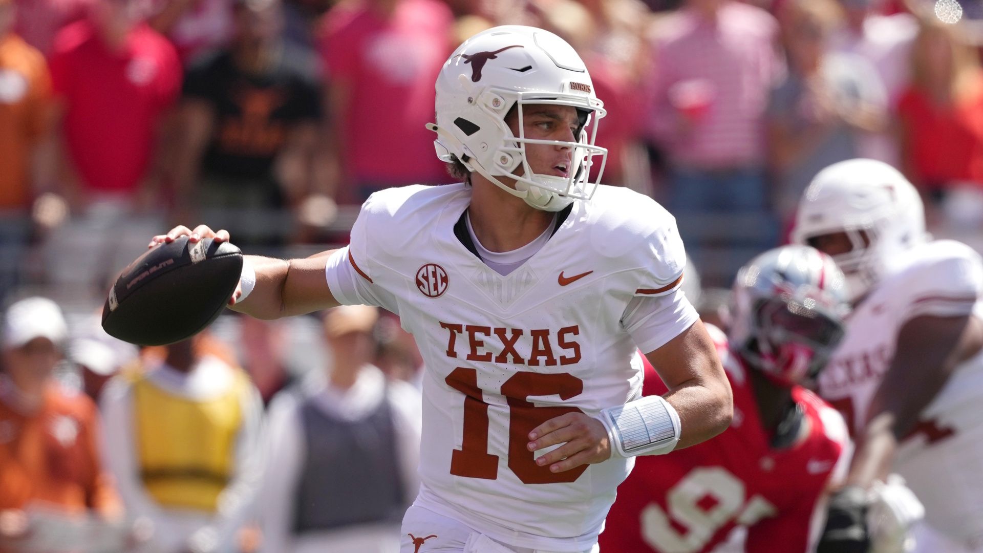 Quarterback Arch Manning #16 of the Texas Longhorns passes the ball during a college football game against the Ohio State Buckeyes.