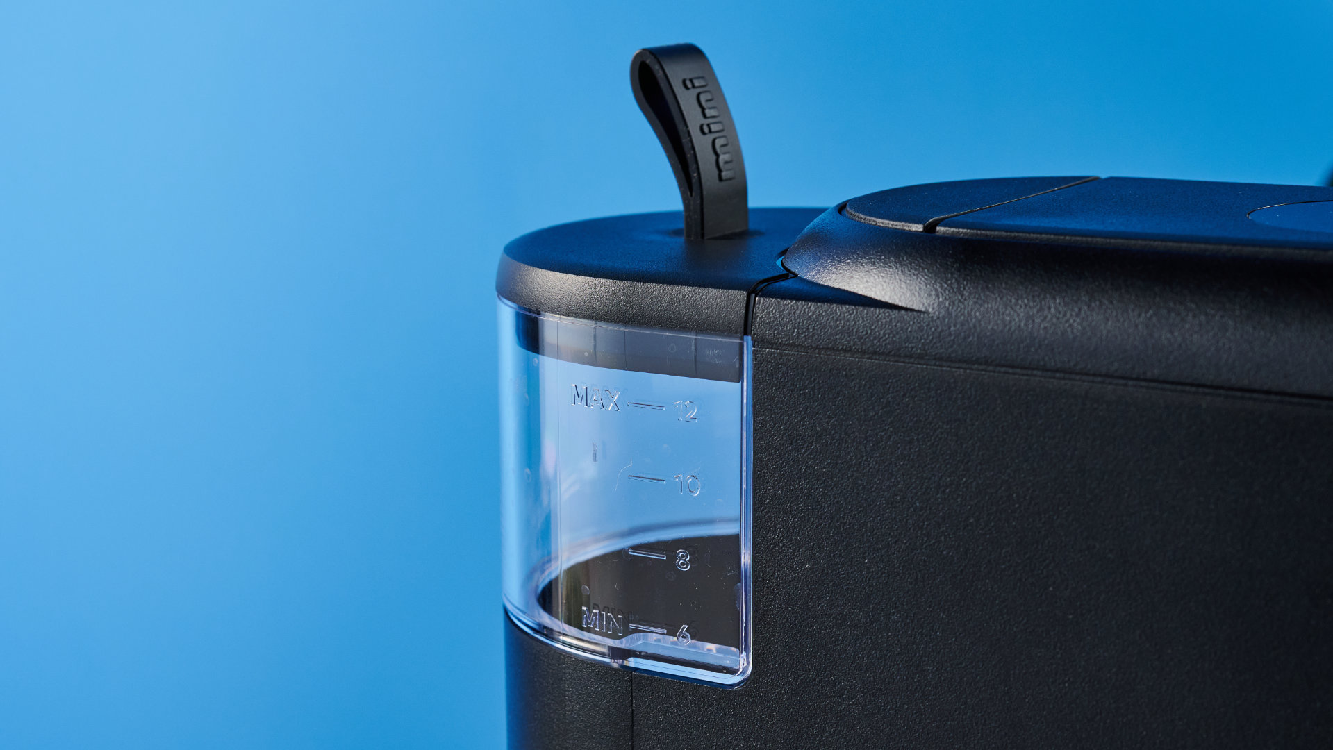 מכונת הקפה keurig k-mini mate שצולמה עם רקע המדריך הכחול