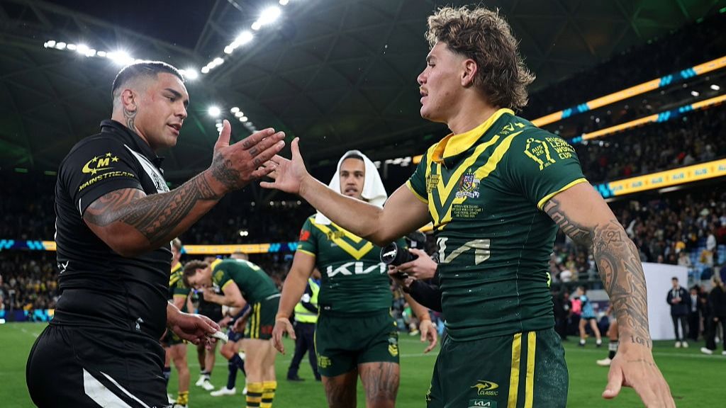 Erin Clark of New Zealand and Reece Walsh of Australia embrace after the opening game of the Rugby League World Cup 2026