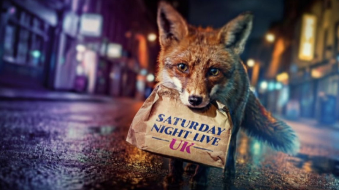 A fox holds a brown paper bag with 'Saturday Night Live' written on it