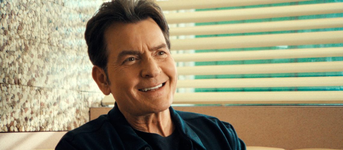 Charlie Sheen seated at a diner booth in the Netflix documentary "aka Charlie Sheen"
