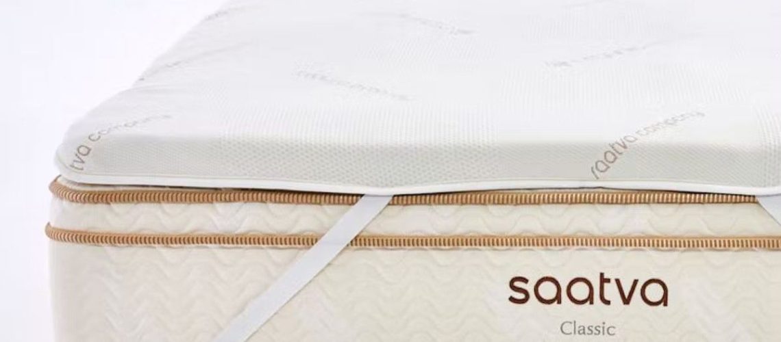 Saatva graphite topper secured via thick elasticated bands to a Saatva luxury mattress