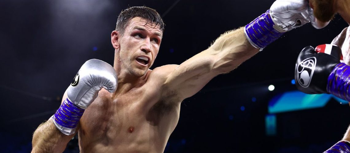 Callum Smith, in red and white shorts and silver boxing gloves, punches an opponent ahead of the Beterbiev vs Smith live stream